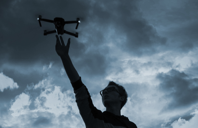 Man holding a drone with his hand