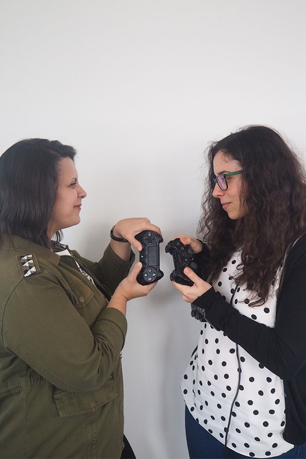 Two women pretending to be using console controllers